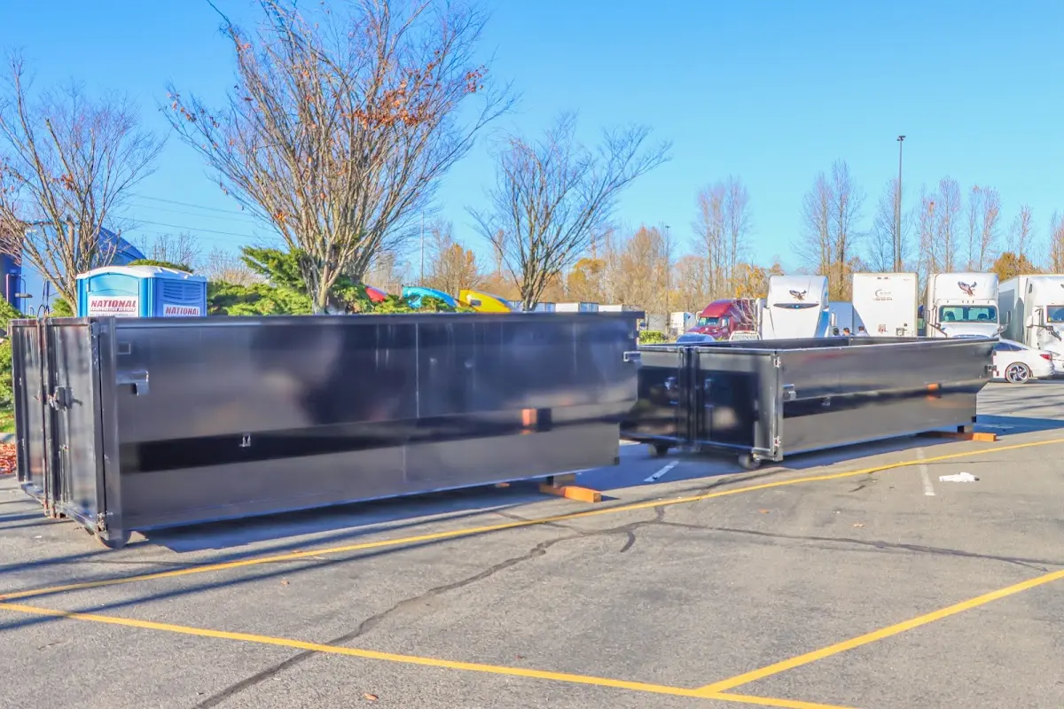 Professional dumpster rental service with roll-off container on residential driveway in Vallejo